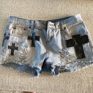 Cut off denim shorts with black crosses